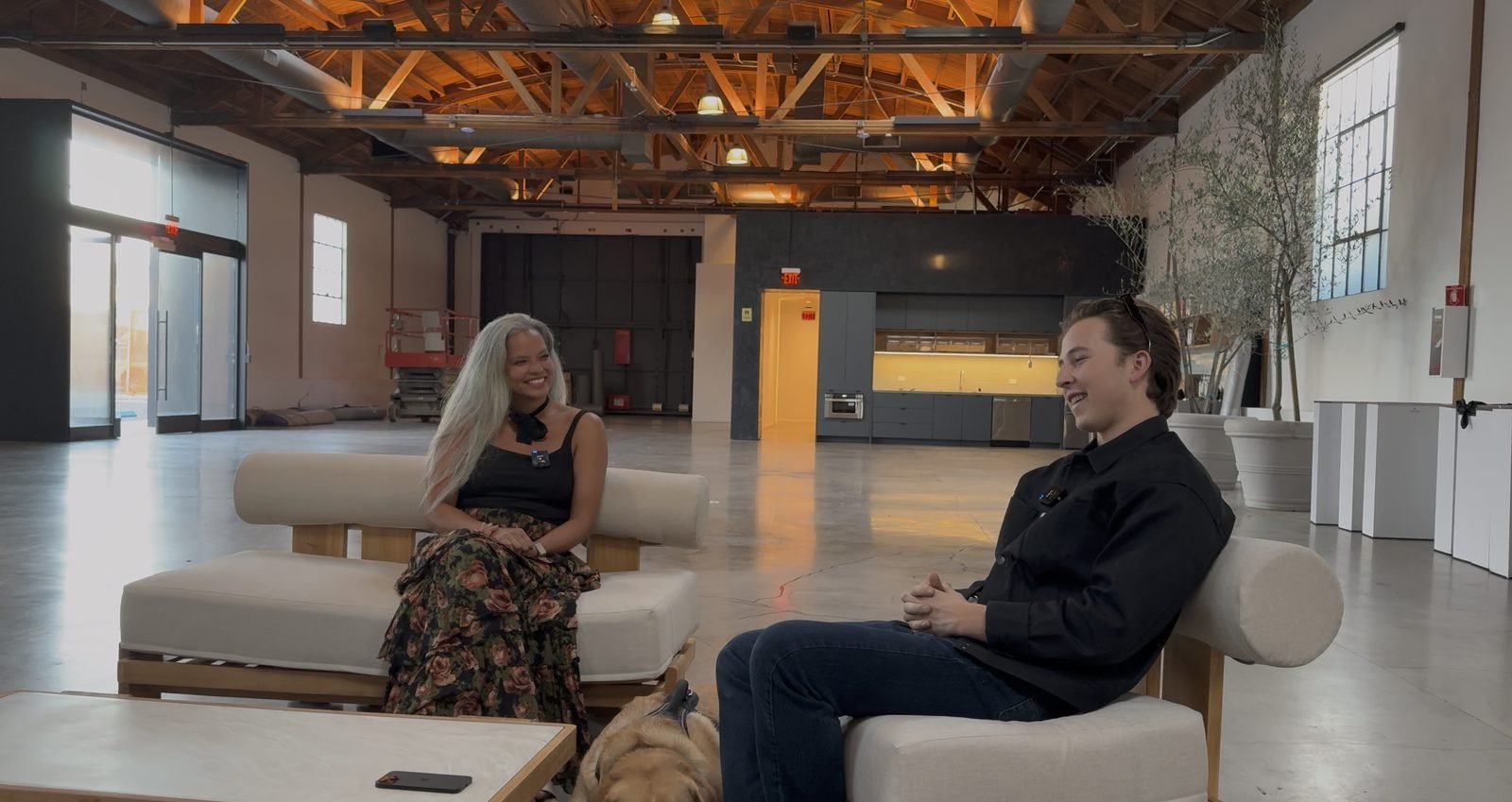 Yewan Fitz-Earle and Farah Casis seated on sofas recording a podcast episode inside The Lillian event venue