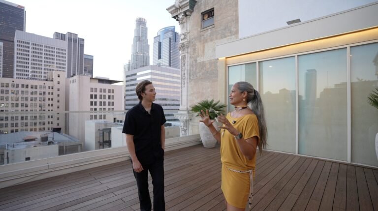 Yewan Fitz-Earle with Farah Casis, Director of Sales at Royva, on the deck at Savanna Rooftop with the city skyline behind them